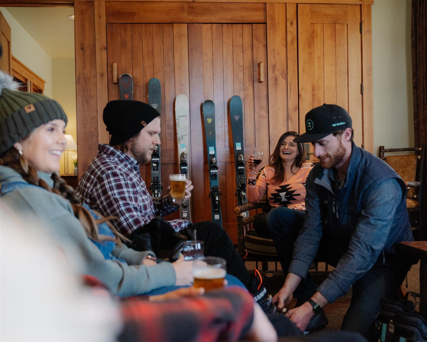 Ski Butler Employee Helping a Person around frineds drinking